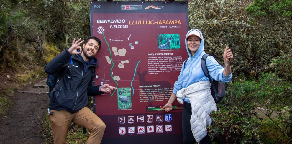 "Excursionists arriving at Llulluchapampa, a stunning Inca Trail campsite with views of the surrounding mountains."